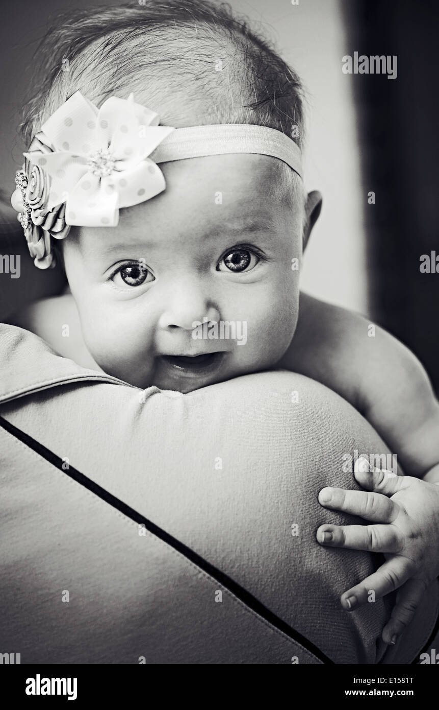Newborn baby girl on his Mothers shoulder in black and white Stock Photo