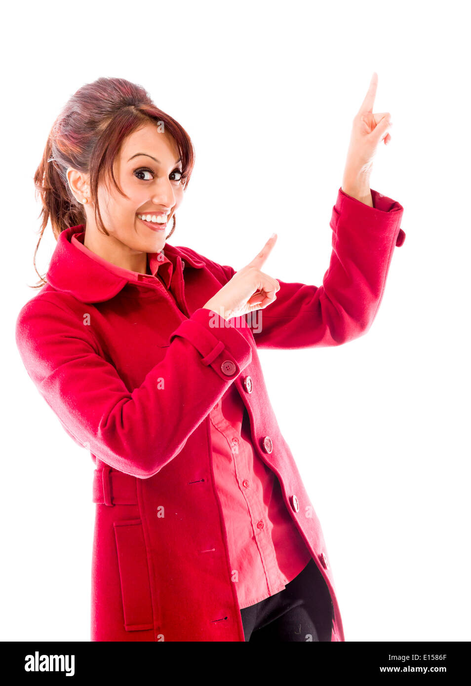 Indian young woman pointing upward and smiling Stock Photo