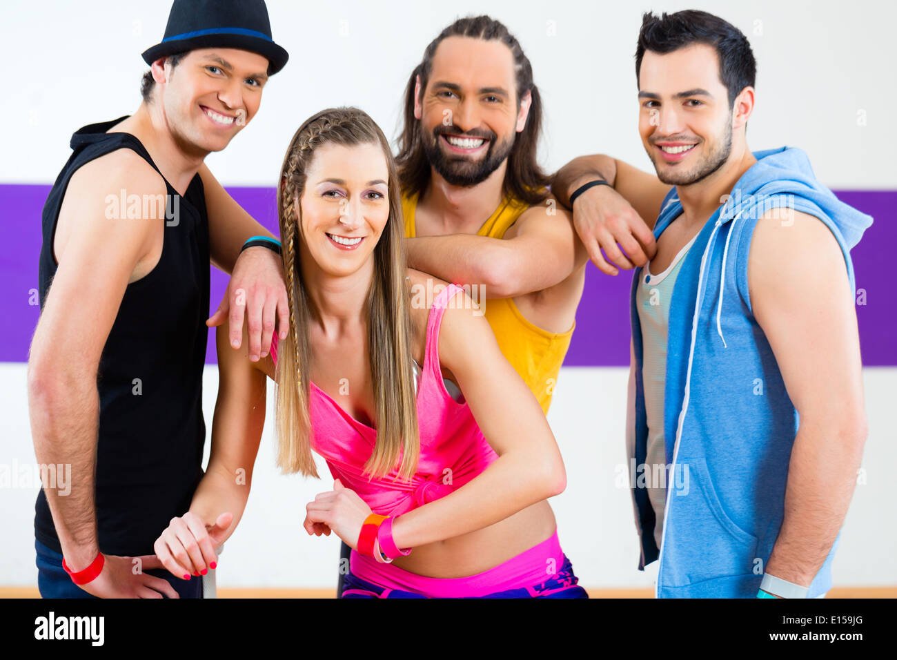 Group of men and women dancing zumba fitness choreography in dance school Stock Photo