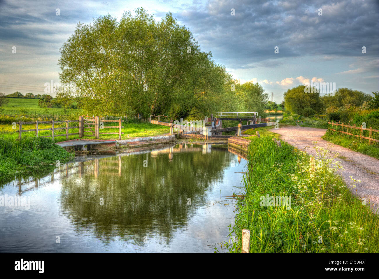 English countryside scene with canal and lock gates in colourful bright and vivid HDR Stock Photo