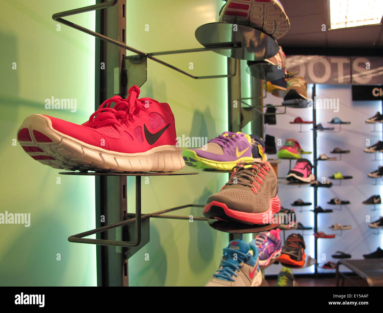 Athletic Footwear Wall with Nikes   with Swoosh Logo,, Modell's Sporting Goods Store Interior, NYC Stock Photo