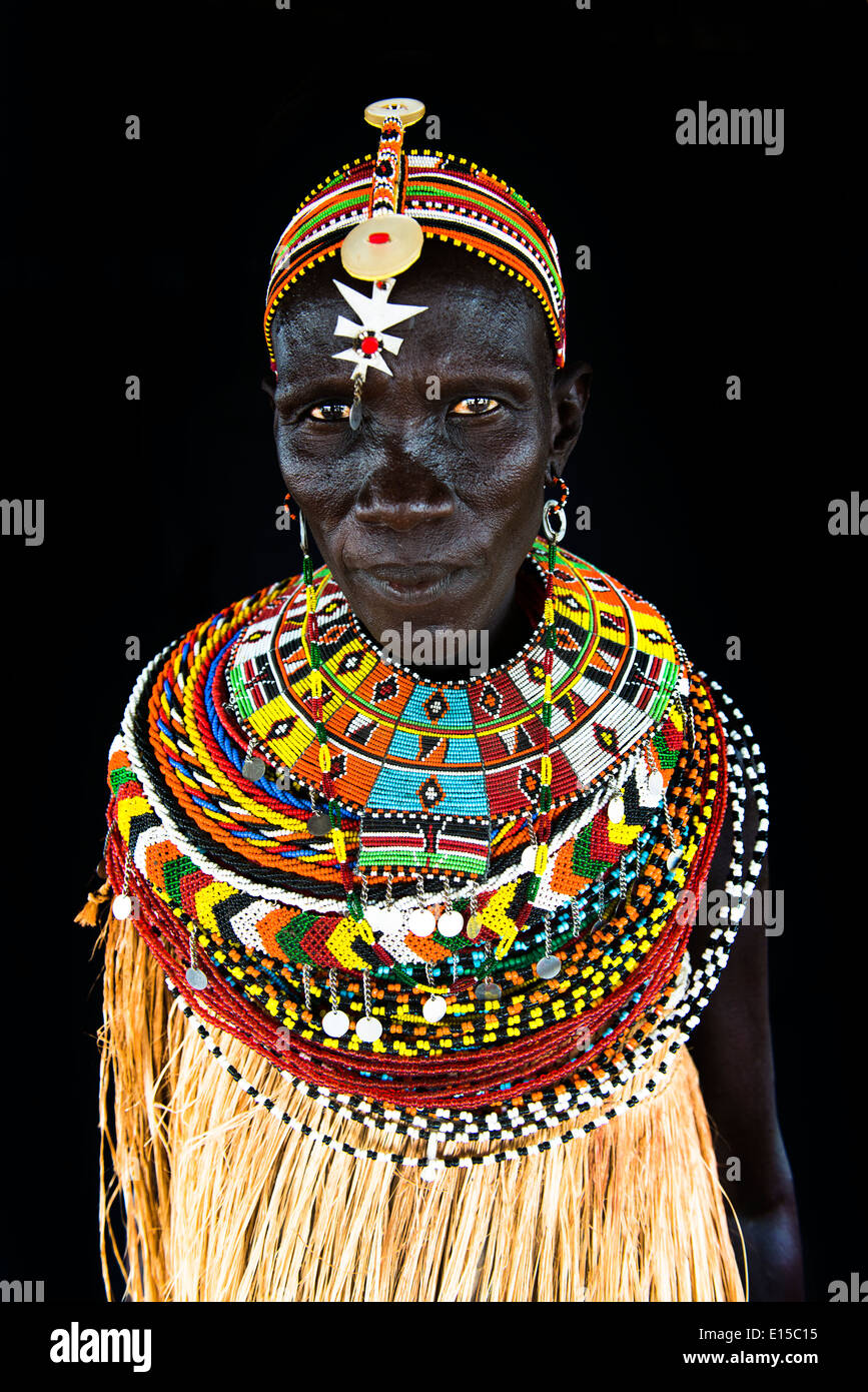 An El-Molo tribal woman dressed in traditional straw dress and colorful beaded necklaces. Stock Photo