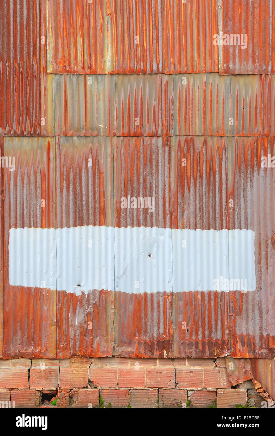 rusted corrugated metal wall of a warehouse building in a industrial