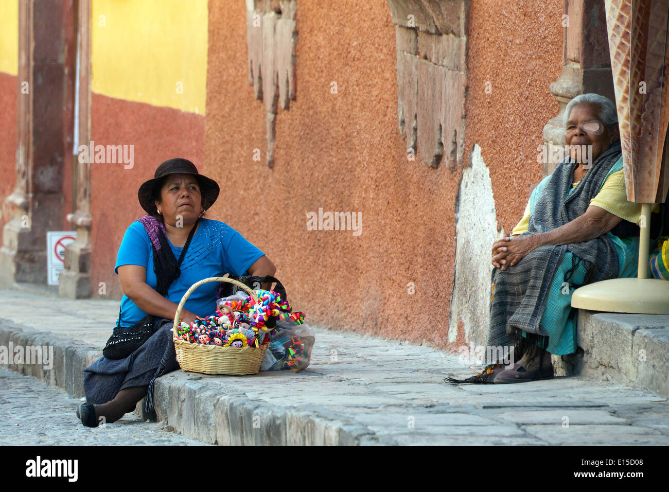 Two Indian women seated on pavement San Miguel de Allende Mexico Stock Photo