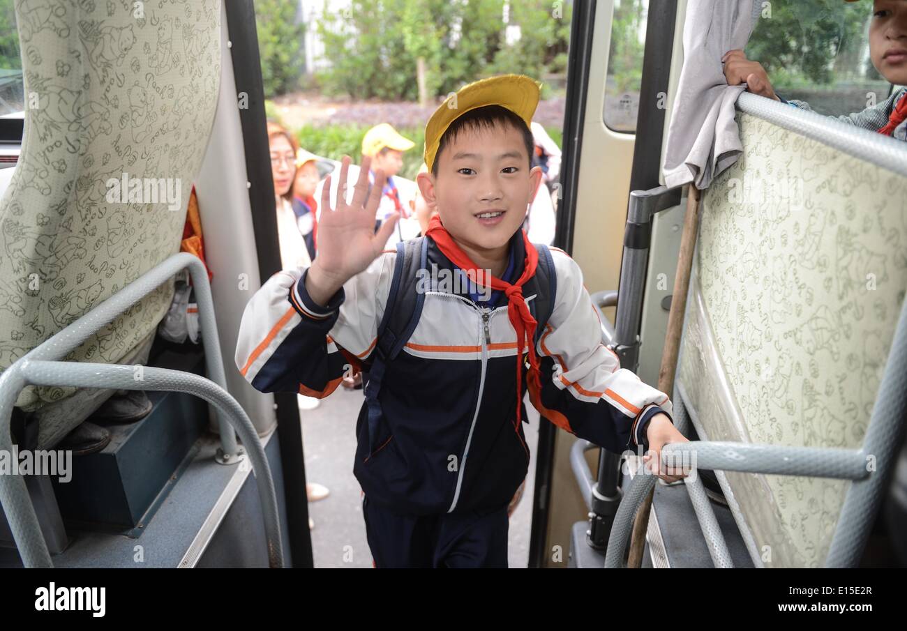 (140523) -- DEQING COUNTY, May 23, 2014 (Xinhua) -- Students take a government-funded school bus in Deqing County, east China's Zhejiang Province, May 23, 2014. Since 2009, Deqing county has budgeted 25 million yuan (four million U.S. dollars) for school bus purchasing, with an additional annual subsidy of six million yuan (0.96 million U.S. dollars). The county's 93 customized school buses are now taken by nearly 7,000 students commuting between home and school. The school buses, run and managed by a government-owned subsidiary, are equipped with GPS and video monitoring system to ensure road Stock Photo