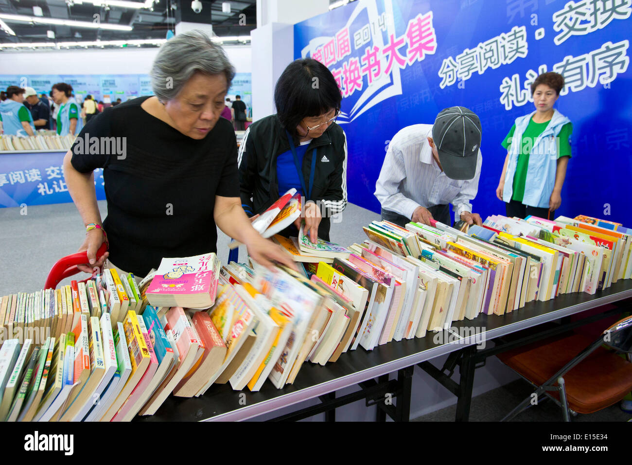 Beijing, China. 23rd May, 2014. Readers attend the fourth Beijing Book Exchange Fair held at the Capital Library of China in Beijing, capital of China, May 23, 2014. The fourth Beijing Book Exchange Fair opened Friday in Beijing. Over 10,000 used books and magazines are available for swaps. © Zhao Bing/Xinhua/Alamy Live News Stock Photo