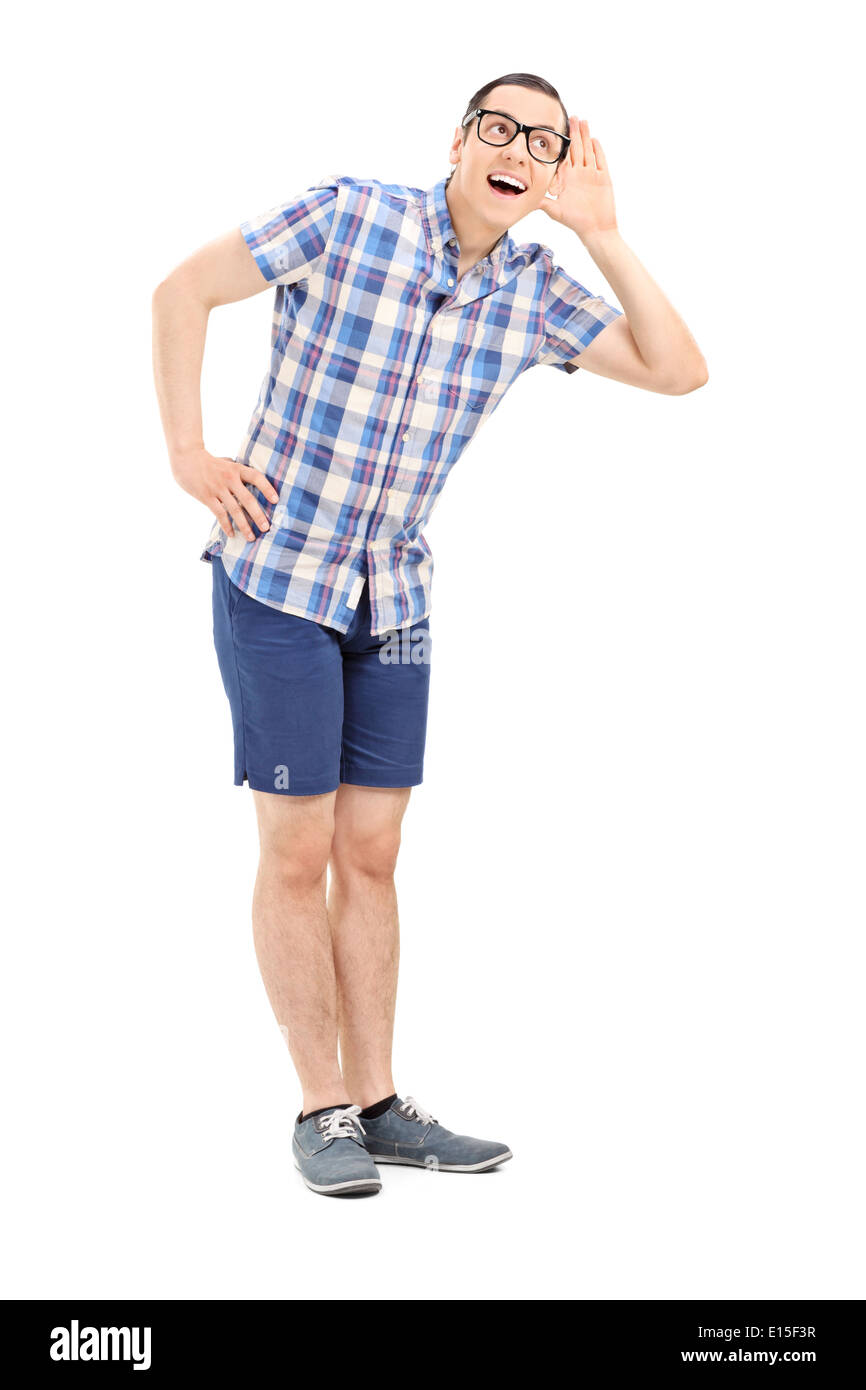 Full length portrait of a young man trying to hear something Stock Photo