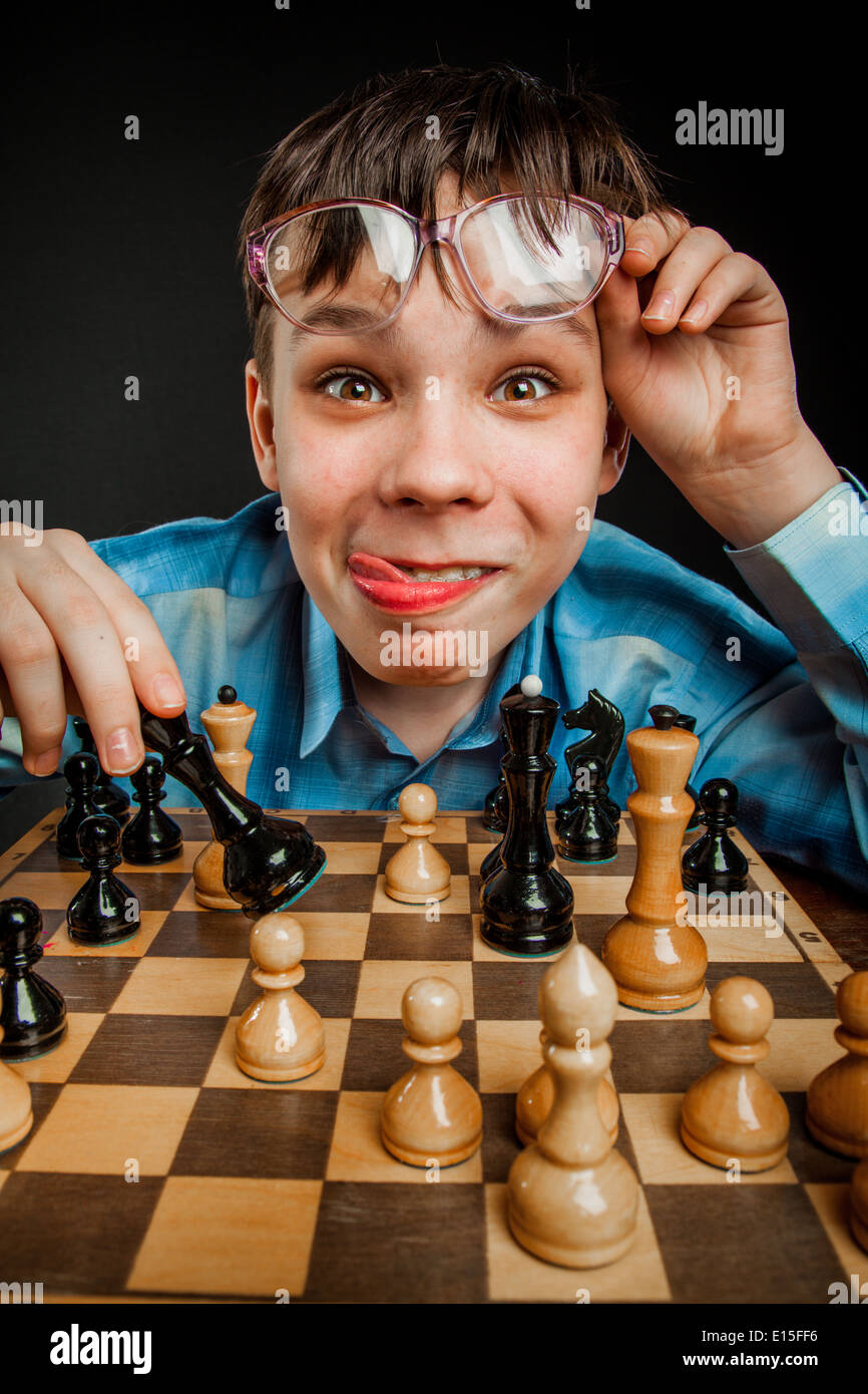 Wunderkind play chess. Funny Nerd boy. Stock Photo