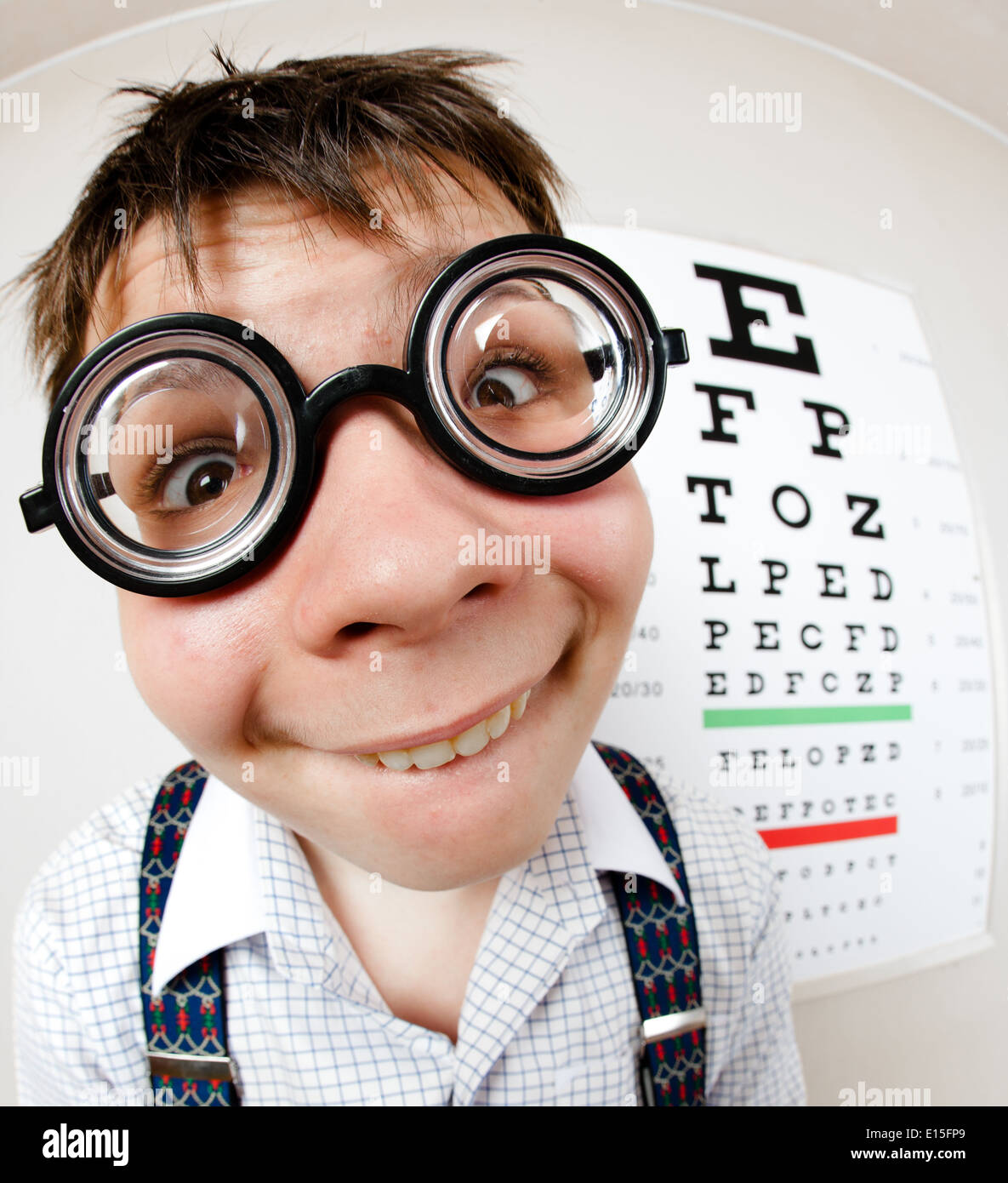 Funny boy wearing spectacles in an office at the doctor Stock Photo