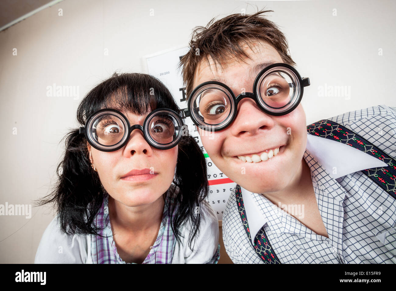 Two funny person wearing spectacles in an office at the doctor ...