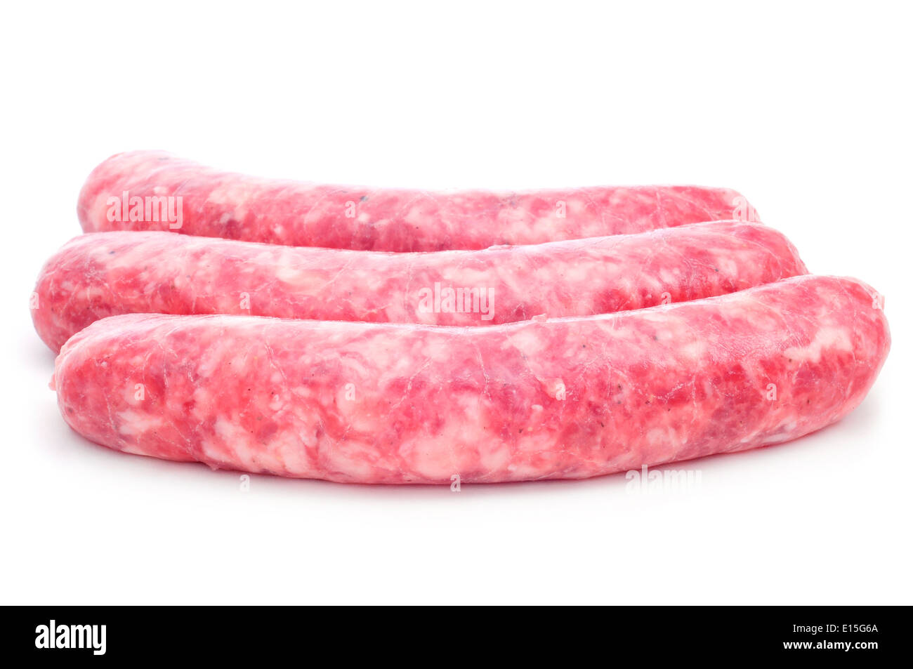 a pile of uncooked pork meat sausages on a white background Stock Photo