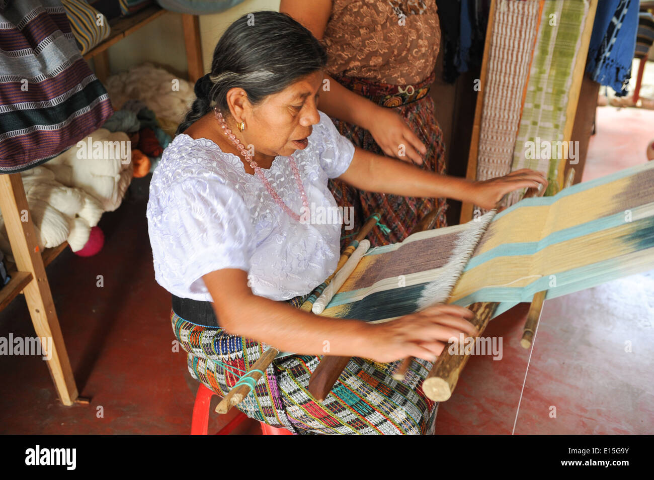 Mayan woman weaving yarns at San Juan la laguna on Guatemala Stock