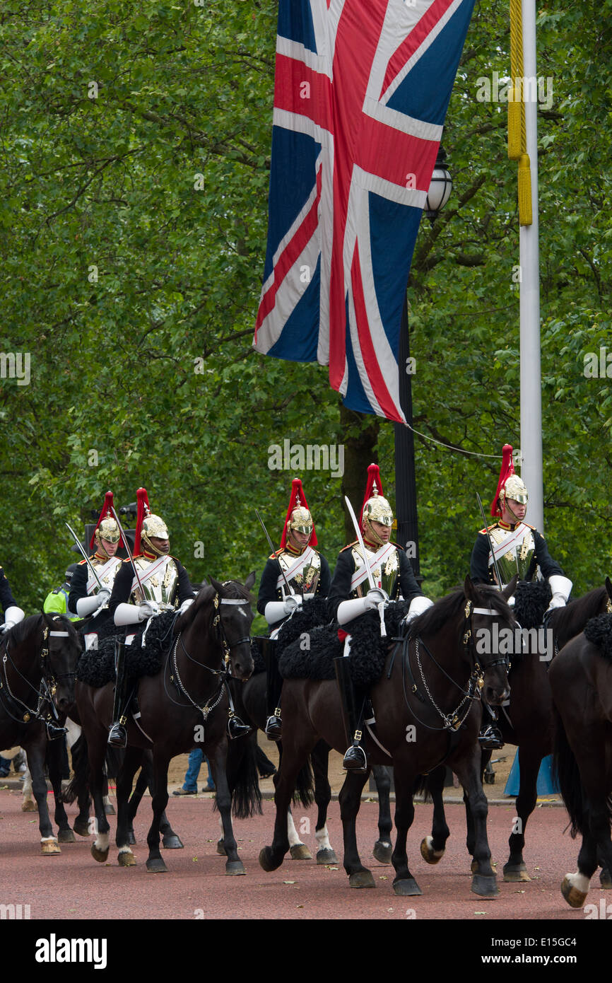 Members of the Household Cavalry, Blues and Royals (Royal Horse Guards and 1st Dragoons) regiment, processing down The Mall, under a large Union Flag, London, England Stock Photo