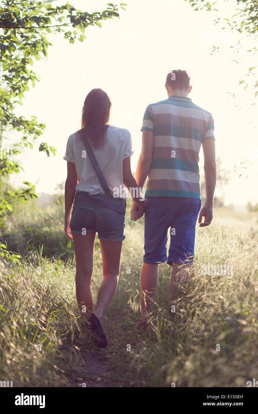 walking loving couple at sunset Stock Photo - Alamy