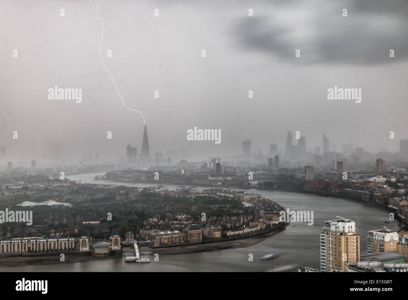 London, UK. 22nd May, 2014. Seen from the Canary Wharf financial district, a bolt of lightning strikes The Shard as a thunderstorm passes through the capital. At 310m tall, The Shard is western Europe's tallest building. Credit:  Steve Bright/Alamy Live News Stock Photo
