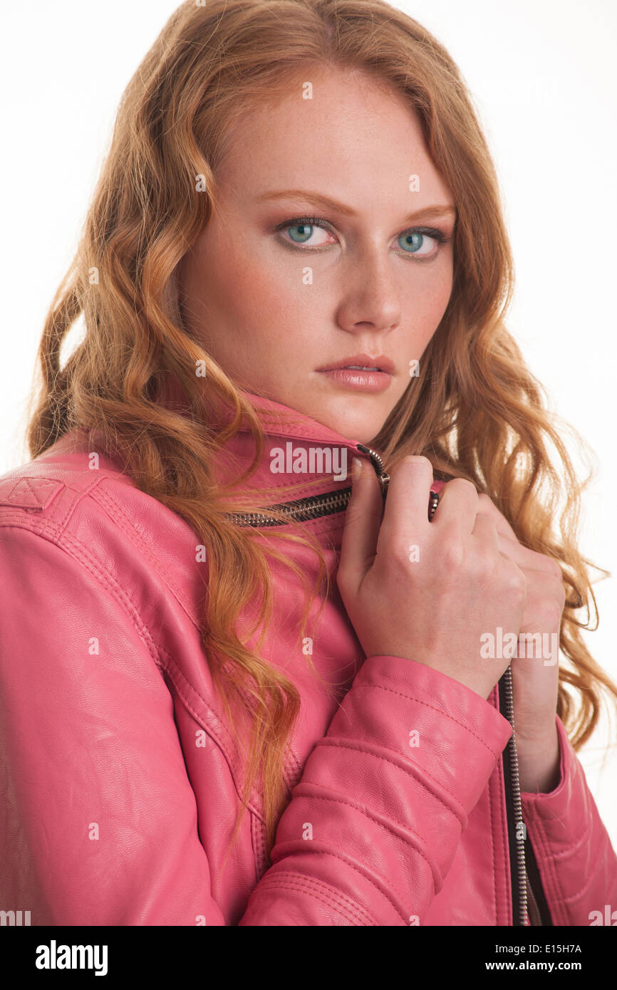 girl with red curly hair wearing pink leather jacket Stock Photo