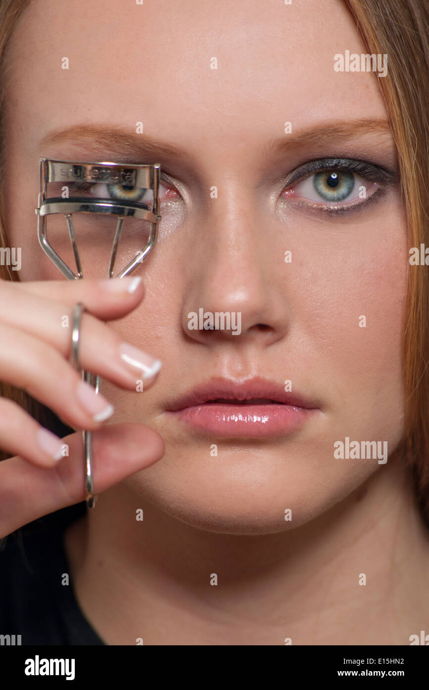 girl using eyelash curlers Stock Photo