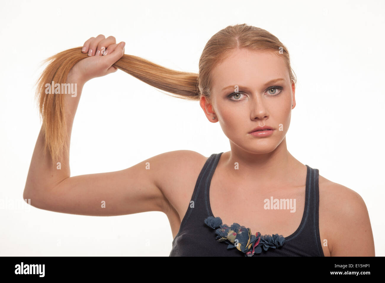 girl pulling her ponytail hair Stock Photo