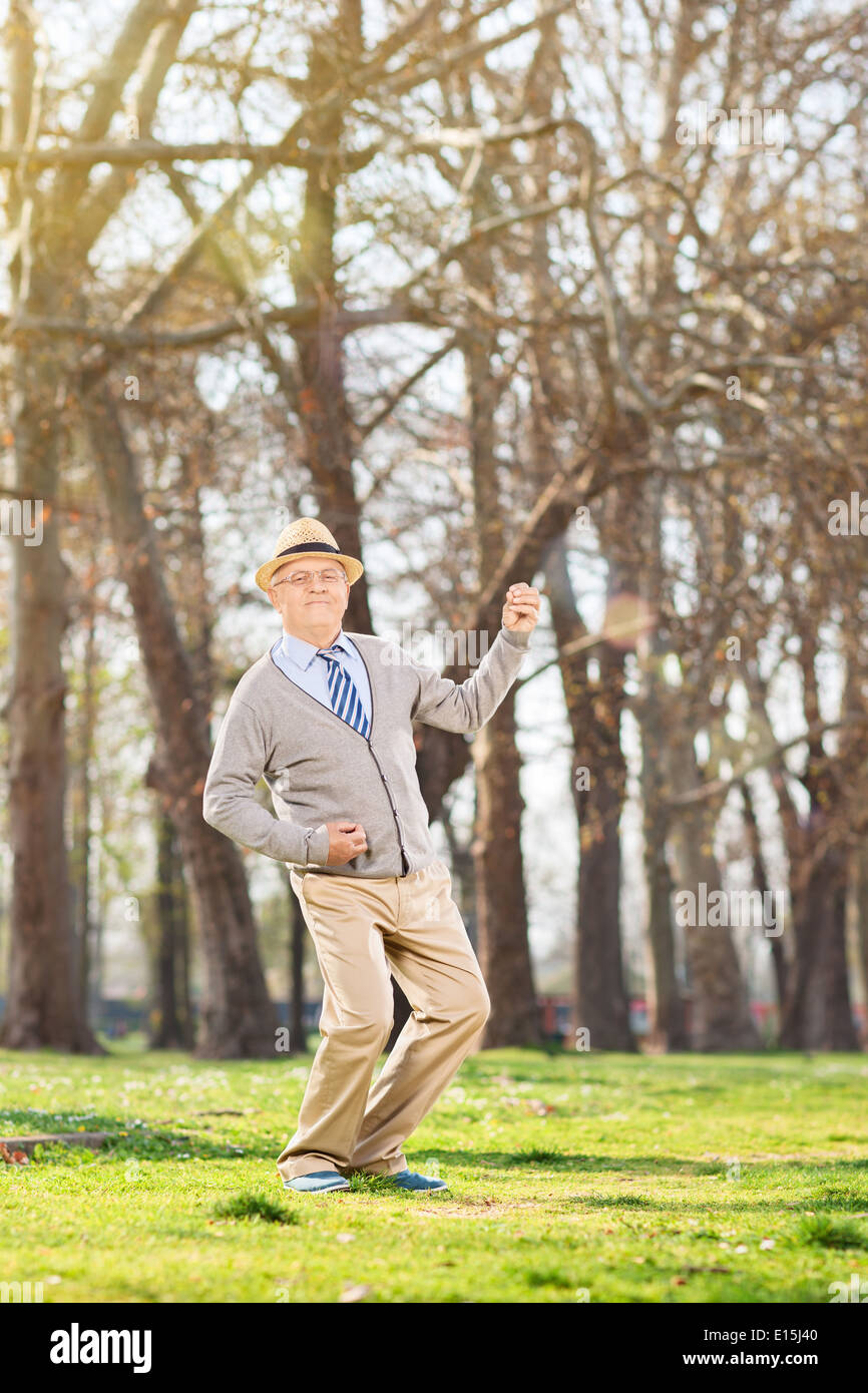 Senior gentleman dancing out of joy outdoors Stock Photo