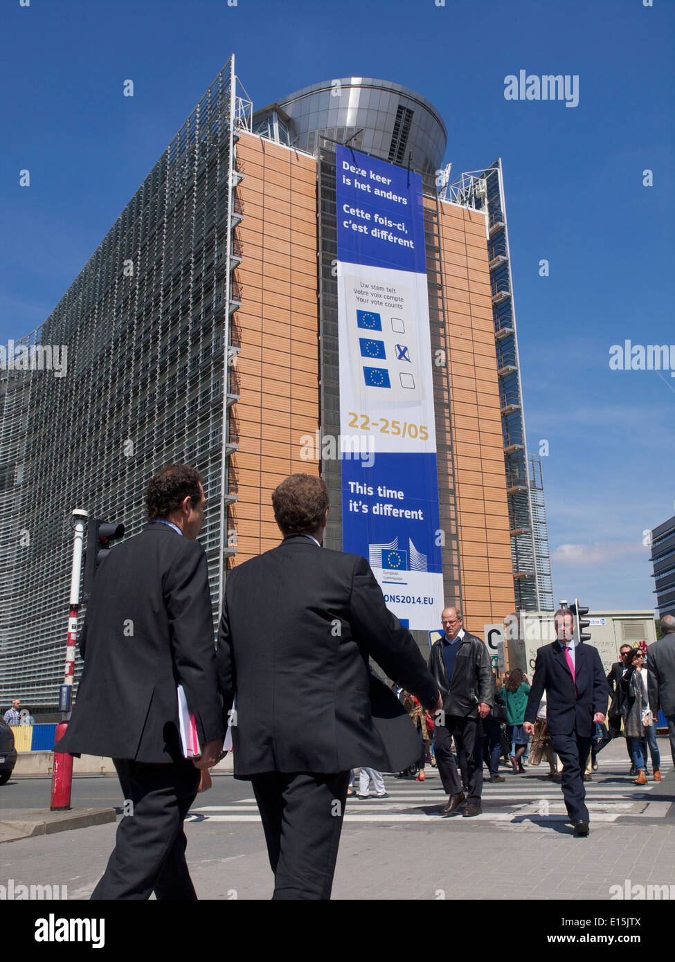 European Commission Berlaymont building with men in suits walking Brussels, Belgium Stock Photo