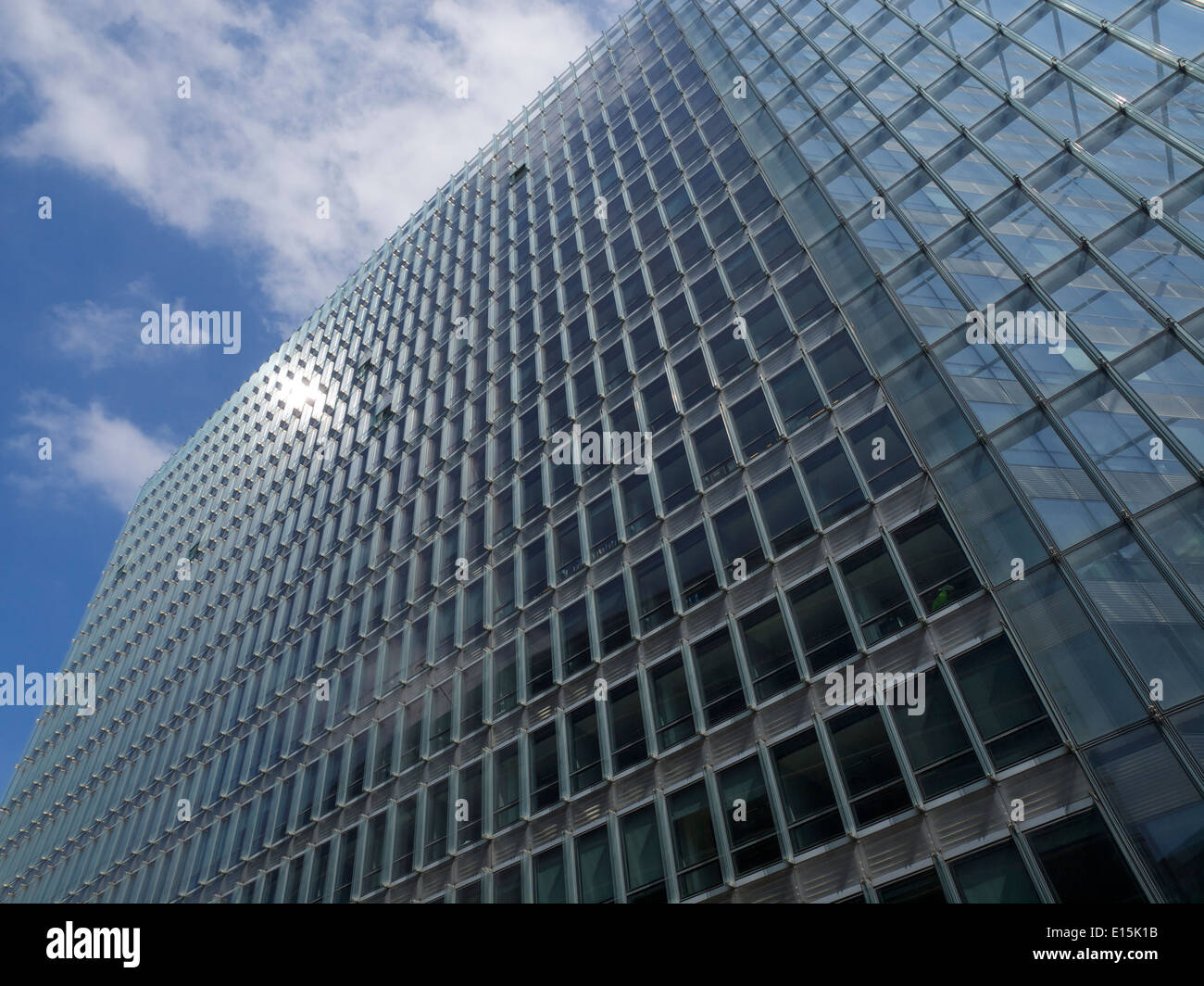 Large European Commission building in Brussels, Belgium, with reflection of the sun Stock Photo