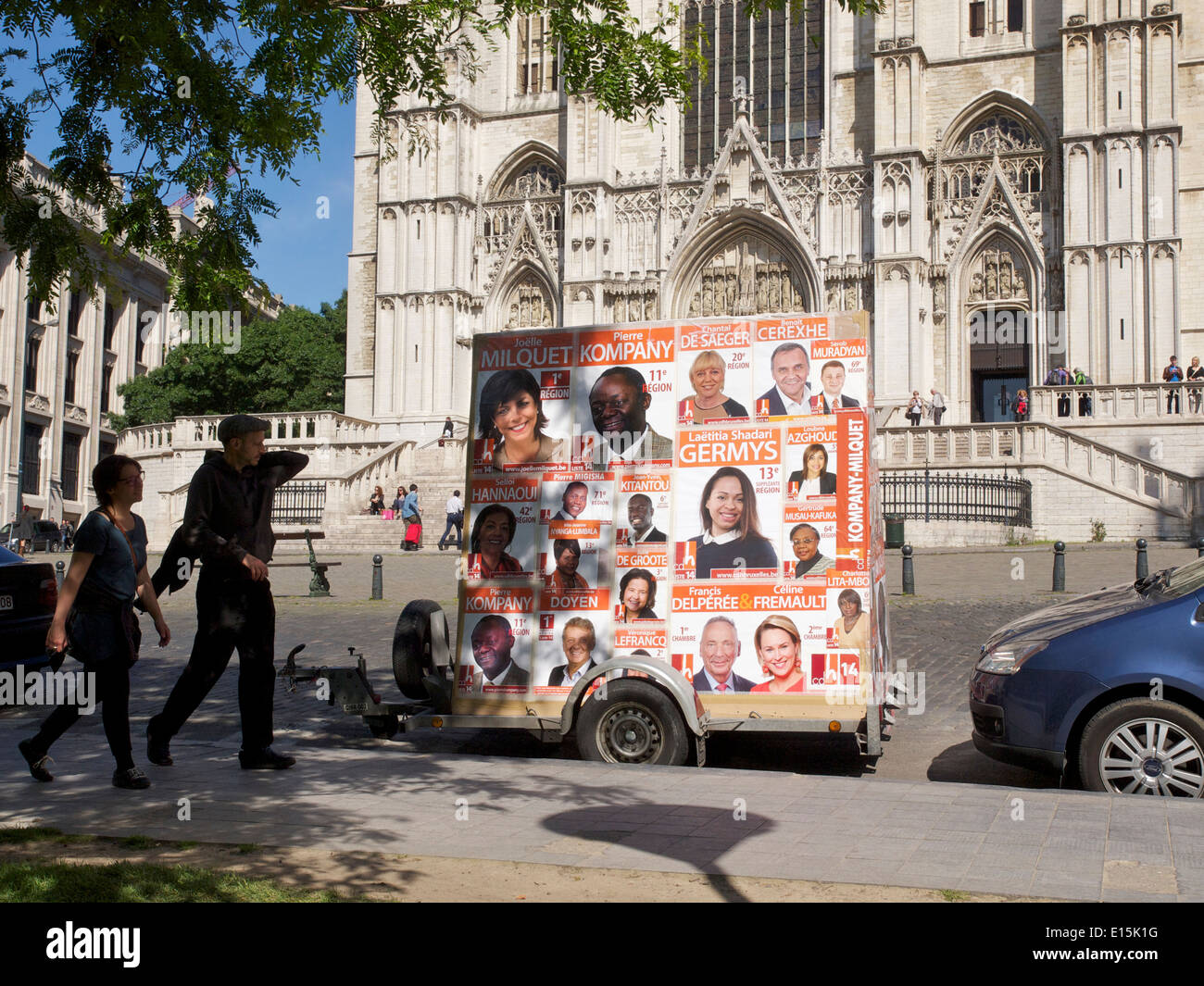 Couple looking at European election posters on a trailer in front of the cathedral in Brussels, Belgium Stock Photo