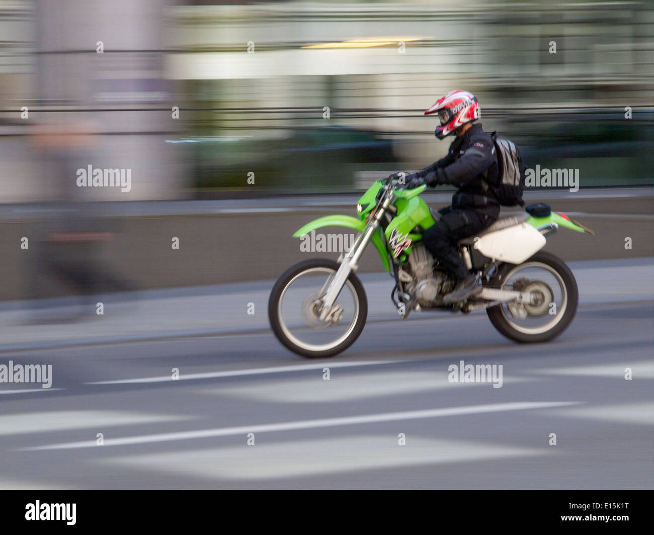 Commuting by motorcycle on the Wetstraat in Brussels, Belgium Kawasaki KLX Stock Photo