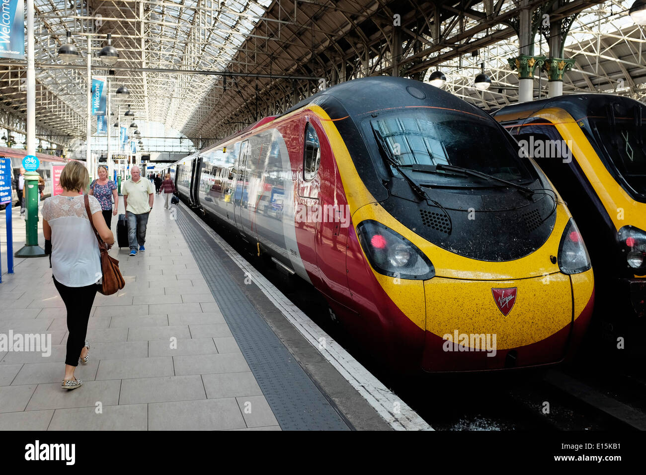 Virgin train and passengers in Piccadilly Station in Manchester city centre UK Stock Photo