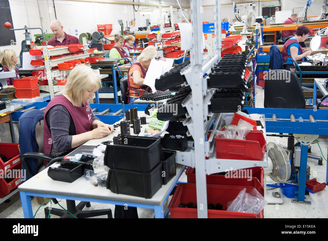 Assembly workers on a factory shop-floor assembling electrical switchgear. Stock Photo