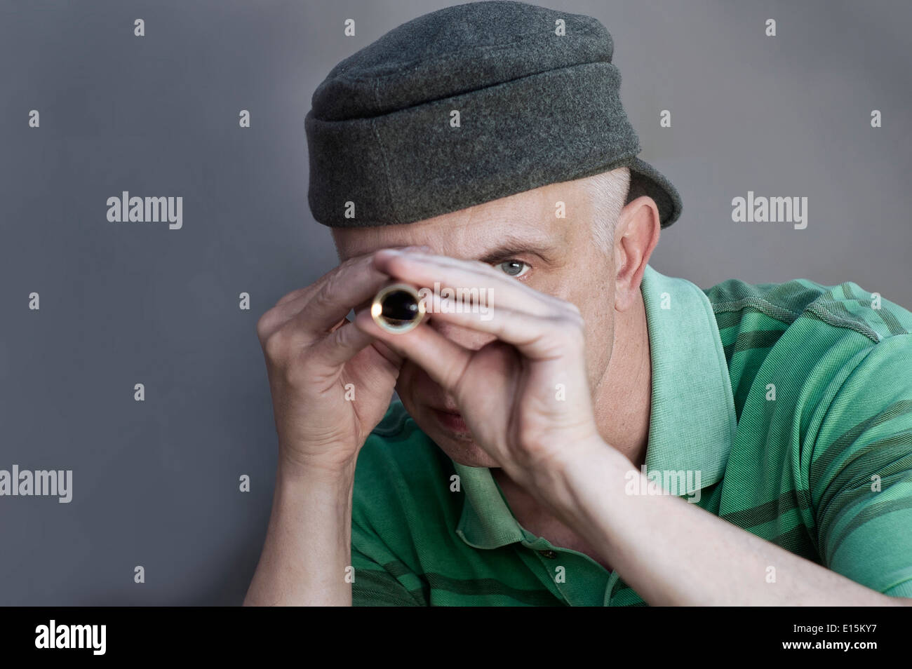 Man holding a spyglassey. Stock Photo