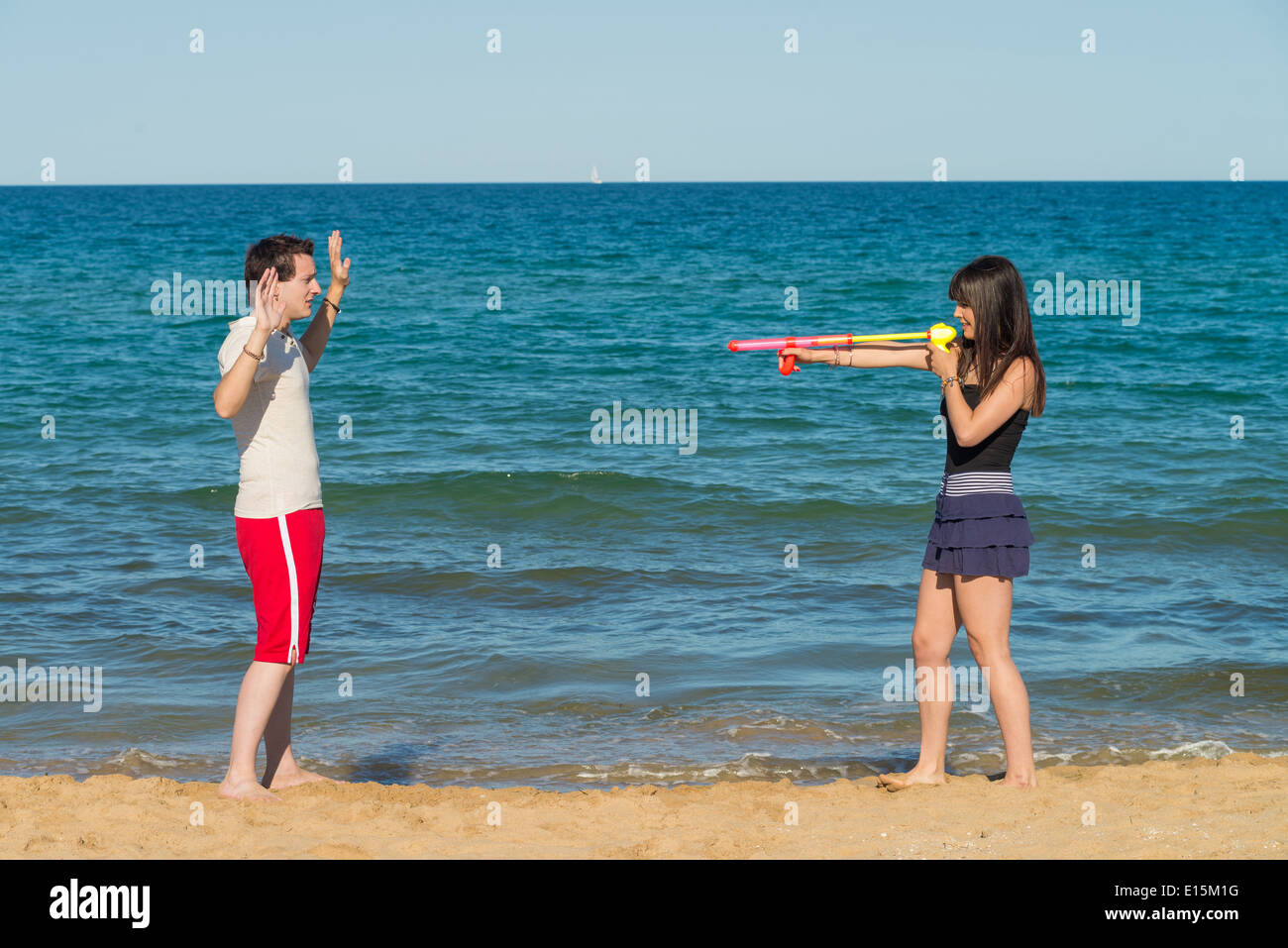 Guy throwing hands up at a squirt gun holdup Stock Photo