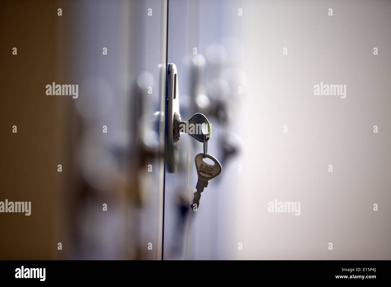 A key in a lock on a locker in an office gymnasium swimming pool changing room dressing room. Stock Photo