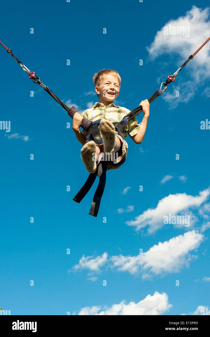 Happy boy jumping on a trampoline Stock Photo