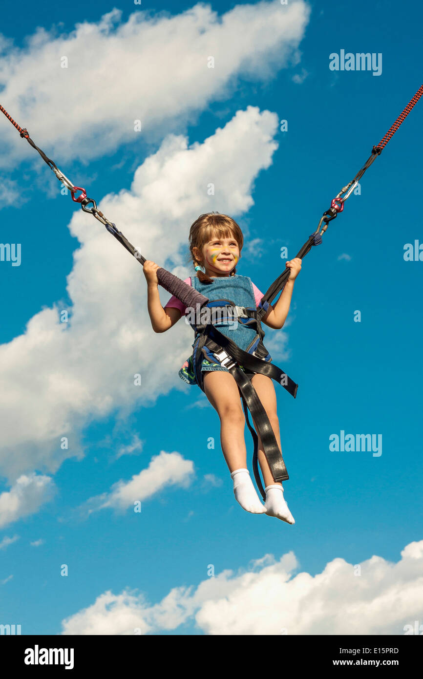 Happy girl jumping on a trampoline Stock Photo