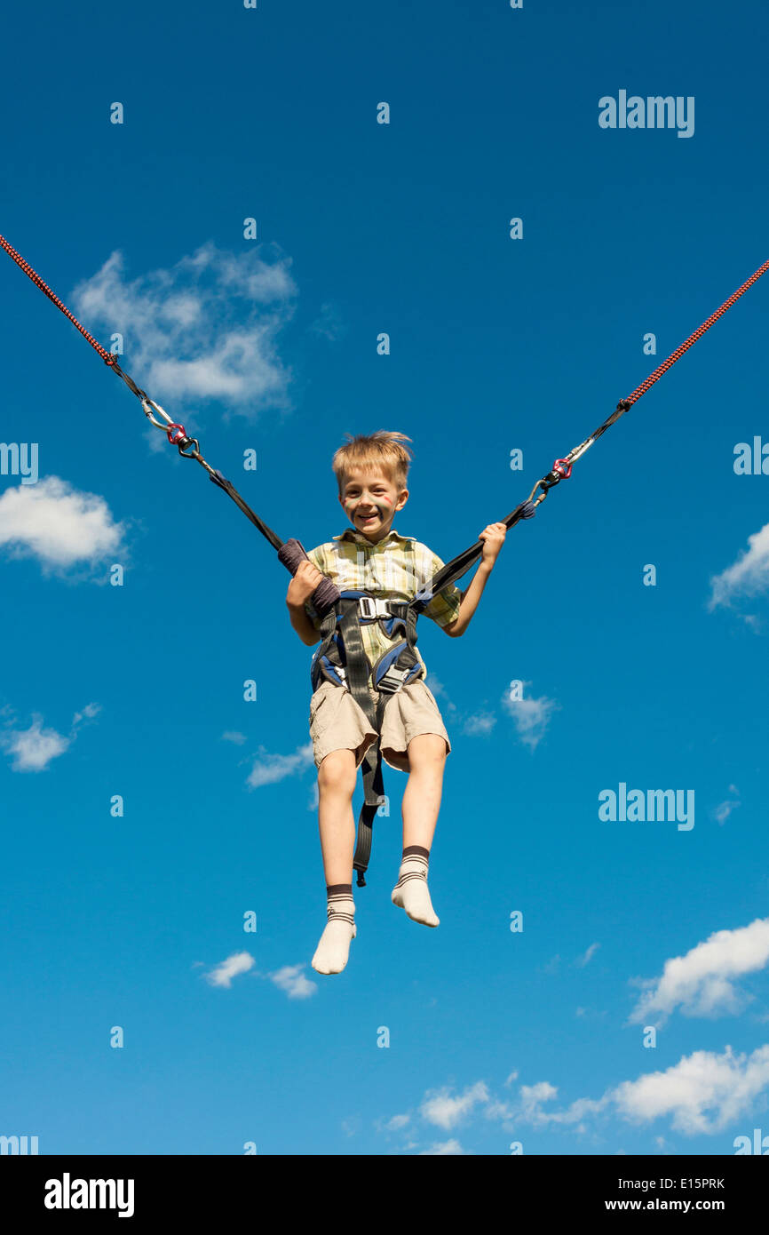 Happy boy jumping on a trampoline Stock Photo