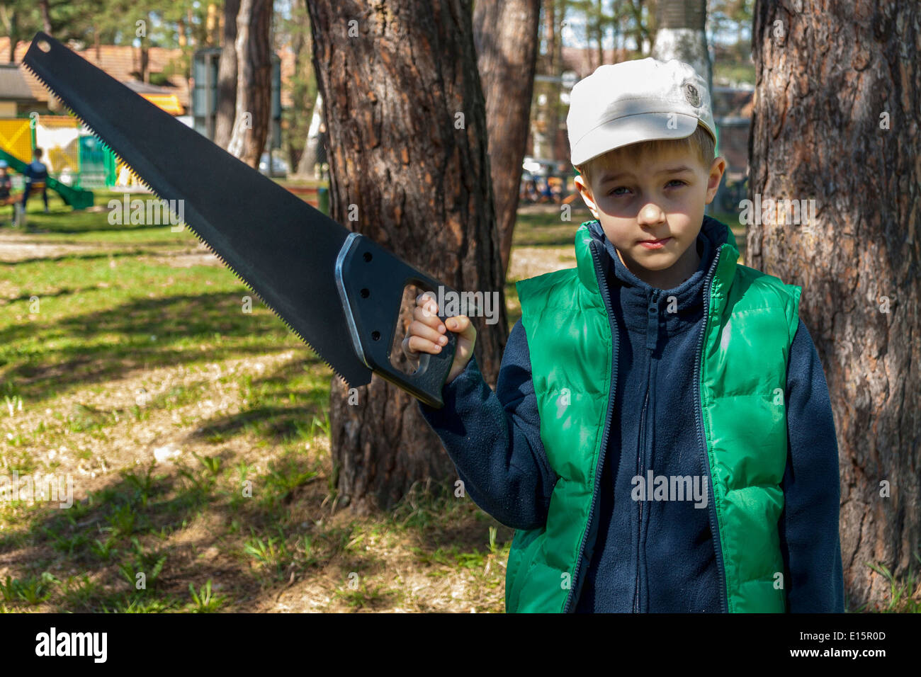 Boy holding handsaw Stock Photo