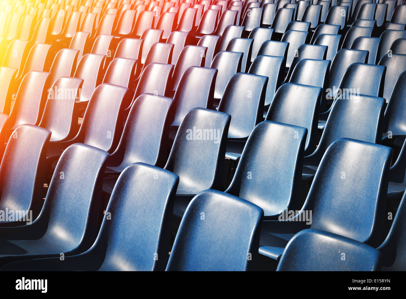 Empty plastic chairs at the stadium, with toning effect Stock Photo