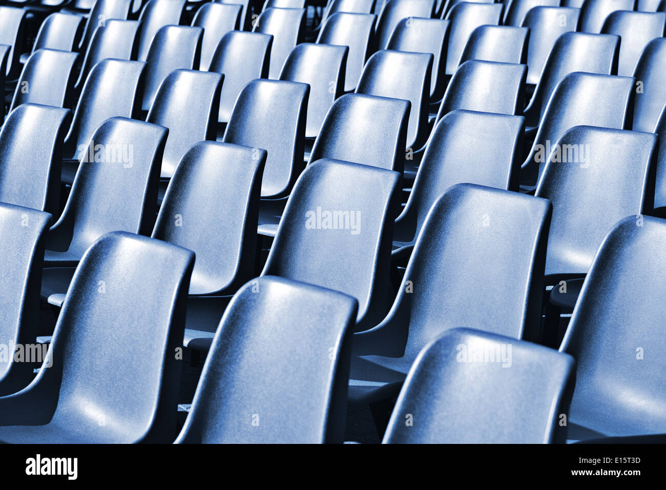 Empty plastic chairs at the stadium, with toning effect Stock Photo