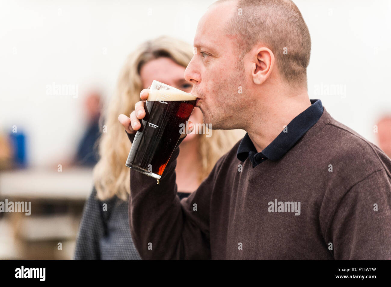 Stock, Essex. 23rd May, 2014.  Andy Woolfenden savours his first pint of ale on the opening day of THE HOOP BEER FESTIVAL, Essex's most famous beer festival.  Over the past twenty years, the Hoop beer festival in Stock Village has become an annual event, drawing serious beer supping folk from as far away as Norway and Australia.  Photographer: Gordon Scammell/Alamy Live News Stock Photo