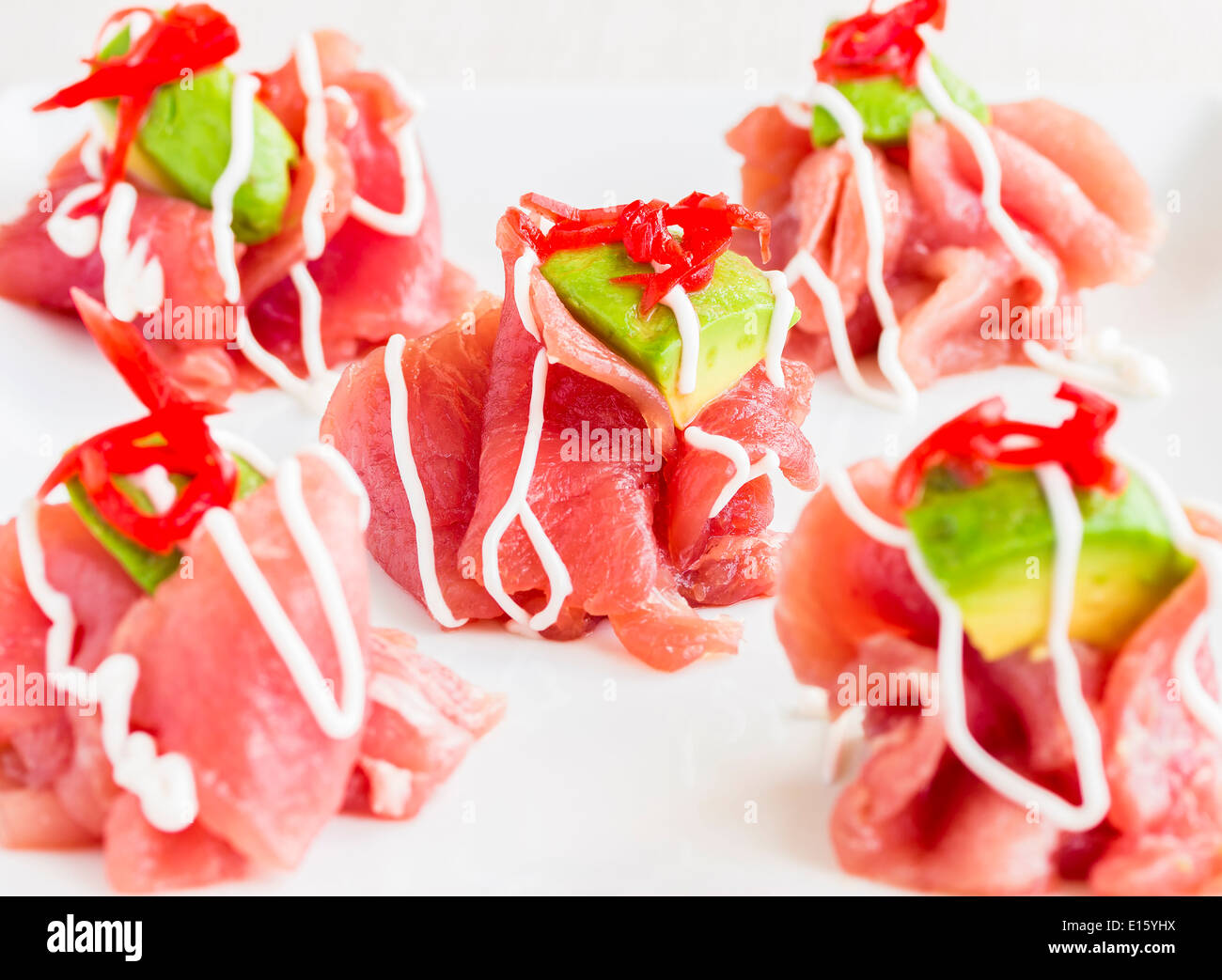Carpaccio of Ahi tuna topped with avocado and pickled ginger, drizzled
