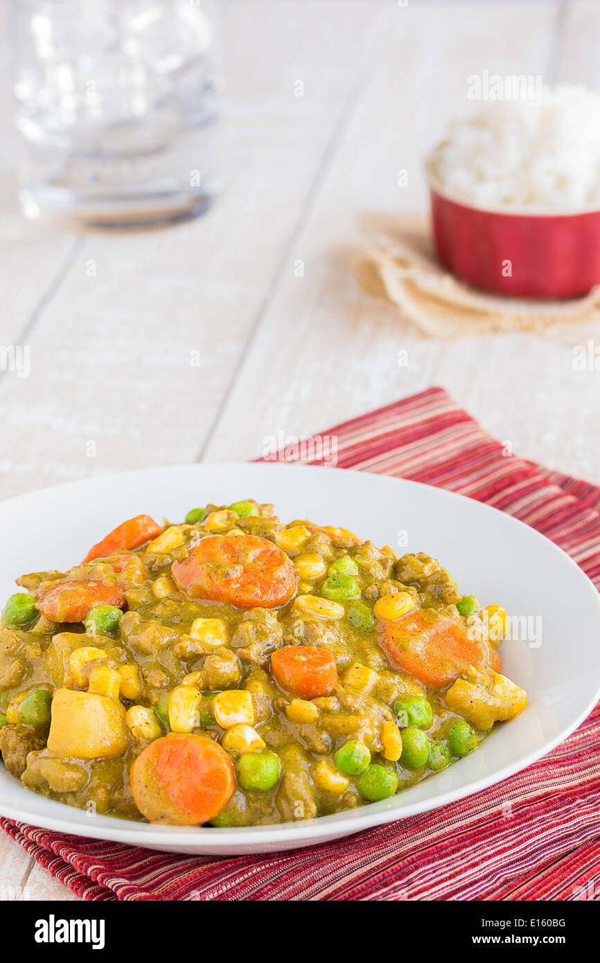 Curry stew made with ground beef, peas, carrots and corn, a common meal