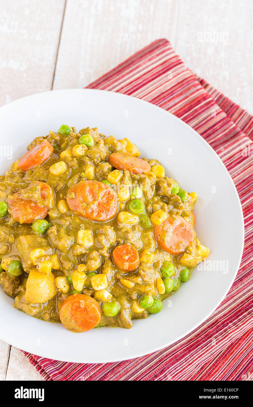 Curry stew made with ground beef, peas, carrots and corn, a common meal
