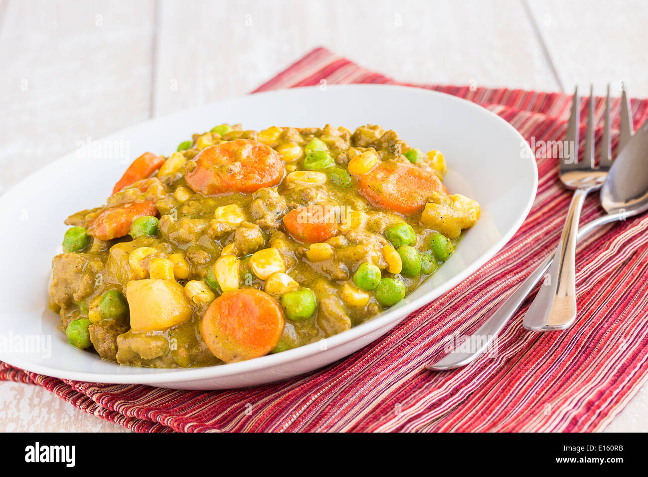 Curry stew made with ground beef, peas, carrots and corn, a common meal