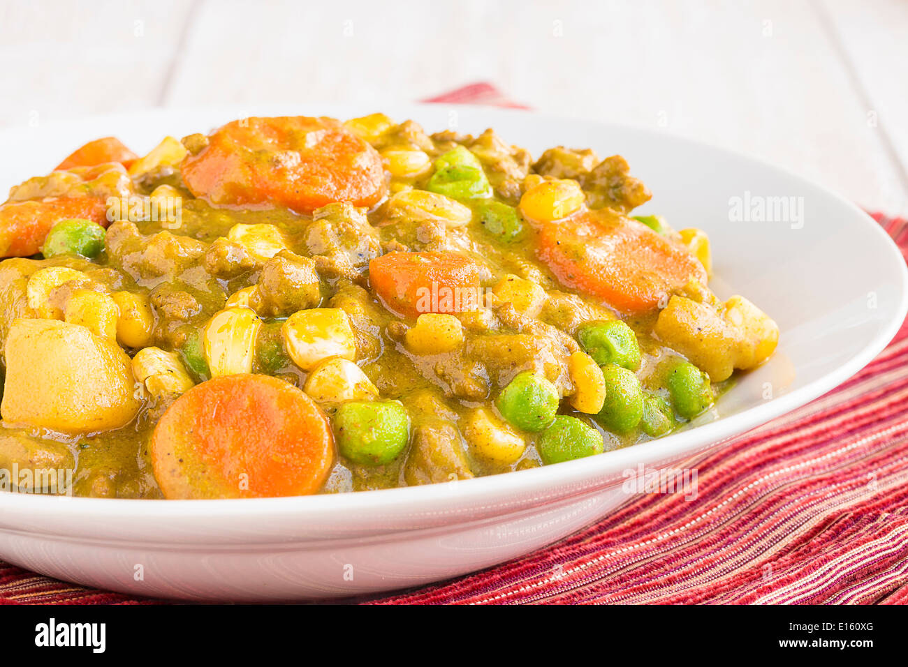 Curry stew made with ground beef, peas, carrots and corn, a common meal