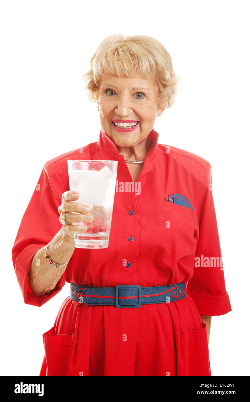 Pretty senior woman drinking a large glass of ice water. Isolated on