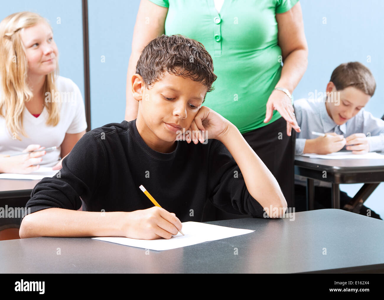Student struggling with a standardized test in school.  Stock Photo