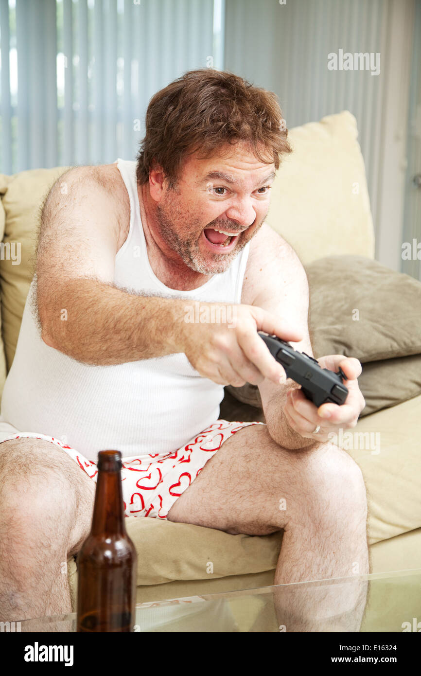 Middle aged man in his underwear playing video games and drinking beer  Stock Photo - Alamy