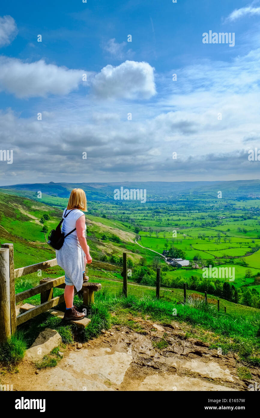 Female walker looking from Mam Tor to the Hope Valley Nr Castleton, Peak District National Park, Derbyshire, England, May Stock Photo