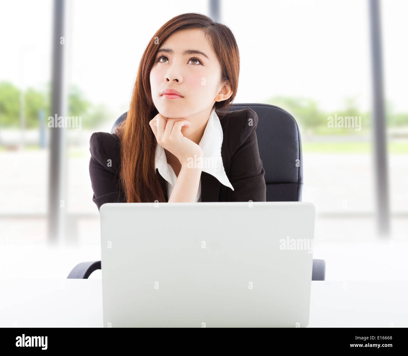 young business woman thinking in the office Stock Photo - Alamy