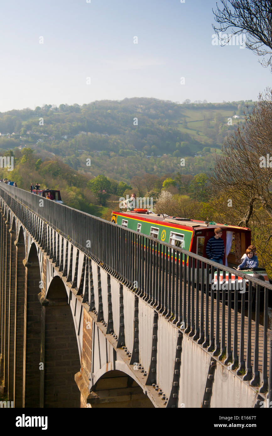 Pontcysyllte Aqueduct with narrowboat crossing Father piloting boat, children sitting at front Stock Photo